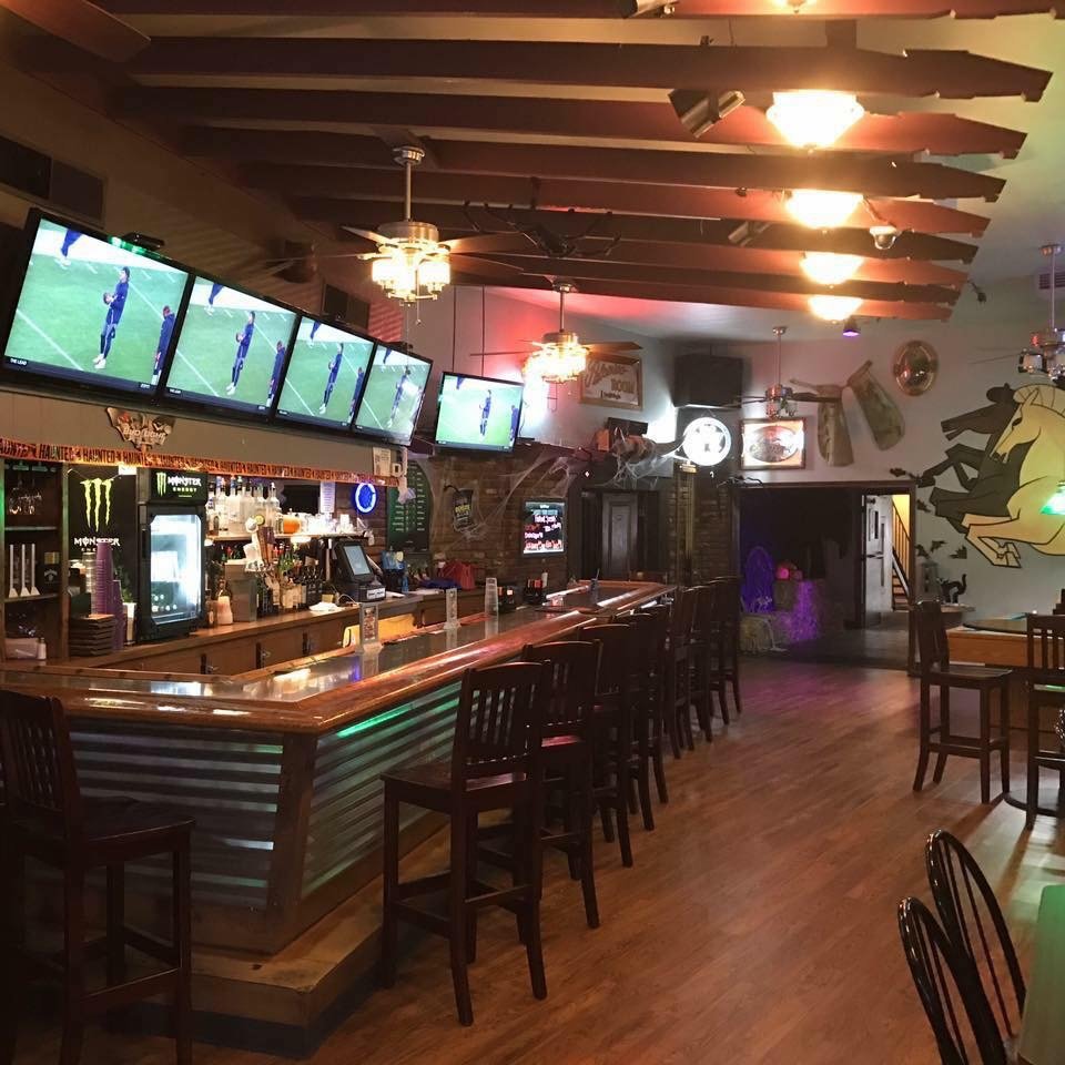 Pizza and burgers in a casual restaurant interior.